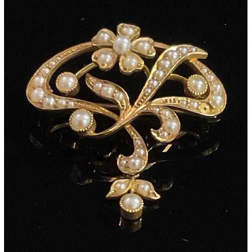 1507 - An Edwardian Art Nouveau seed pearl set pendant brooch, stamped '15ct', the stylised flowerheads wit... 