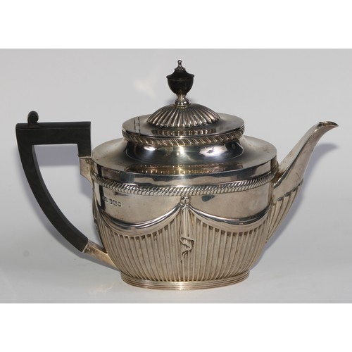 1107 - A Victorian silver three piece half-fluted oval tea service, comprising teapot, milk jug and sugar b... 