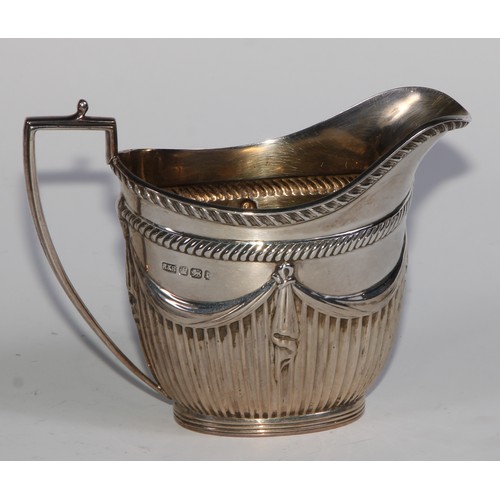 1107 - A Victorian silver three piece half-fluted oval tea service, comprising teapot, milk jug and sugar b... 