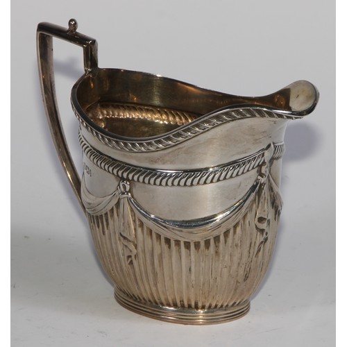 1107 - A Victorian silver three piece half-fluted oval tea service, comprising teapot, milk jug and sugar b... 