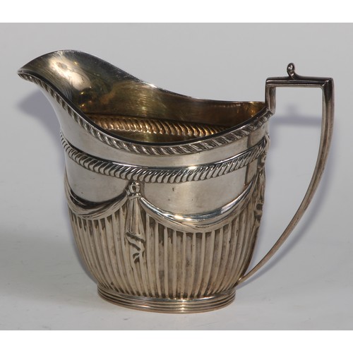 1107 - A Victorian silver three piece half-fluted oval tea service, comprising teapot, milk jug and sugar b... 