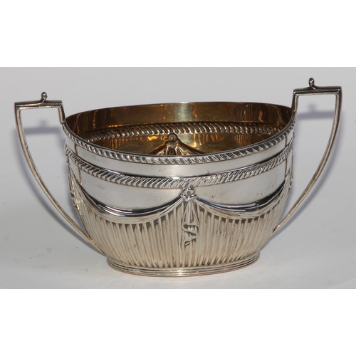 1107 - A Victorian silver three piece half-fluted oval tea service, comprising teapot, milk jug and sugar b... 