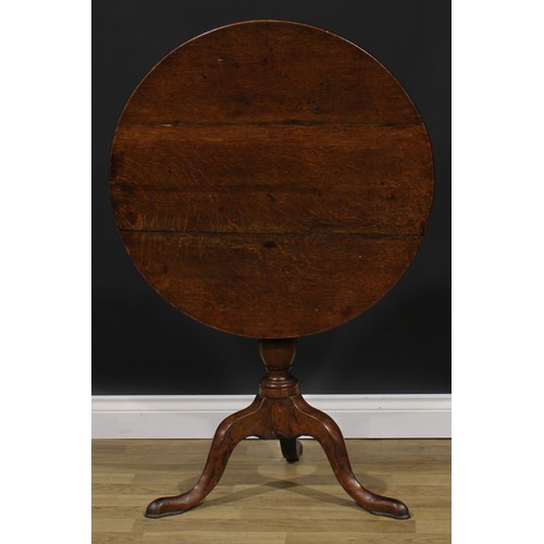 2120 - A George III oak tripod occasional table, circular tilting top, cannon barrel column, cabriole legs,... 