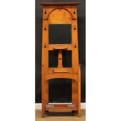 2327 - An Arts & Crafts oak and marquetry hall stand, outswept cornice above an arched moulding encompassin... 