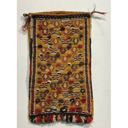 1774 - A Persian Qashqa’i spindle bag, early 20th century, hand-knotted in earthy tones of ochre, brown, wh... 