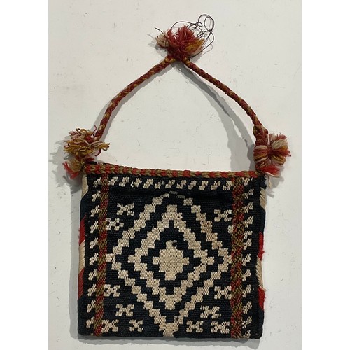 1774 - A Persian Qashqa’i spindle bag, early 20th century, hand-knotted in earthy tones of ochre, brown, wh... 