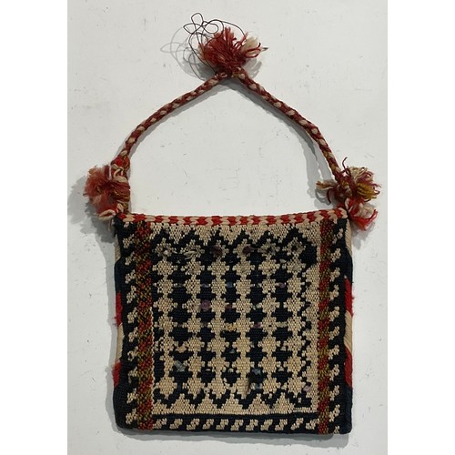 1774 - A Persian Qashqa’i spindle bag, early 20th century, hand-knotted in earthy tones of ochre, brown, wh... 