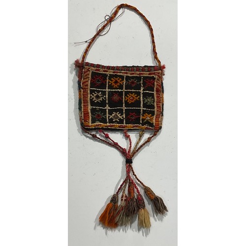 1774 - A Persian Qashqa’i spindle bag, early 20th century, hand-knotted in earthy tones of ochre, brown, wh... 