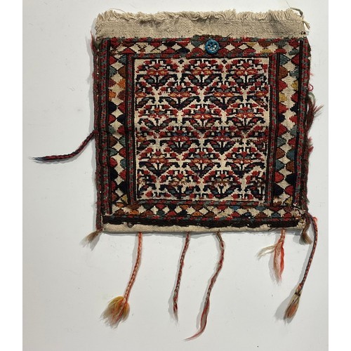 1774 - A Persian Qashqa’i spindle bag, early 20th century, hand-knotted in earthy tones of ochre, brown, wh... 