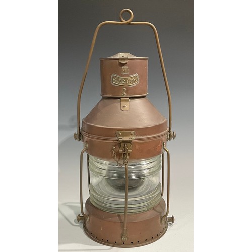 2446 - A copper and brass ship’s lantern, swing carry handle, 62cm high over handle