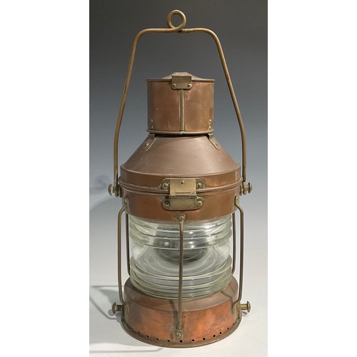 2446 - A copper and brass ship’s lantern, swing carry handle, 62cm high over handle