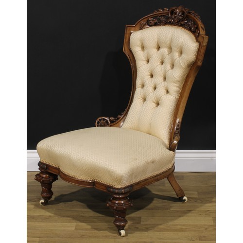 2291 - A Victorian walnut low drawing room chair, shaped cresting rail pierced and carved with bell husks, ... 