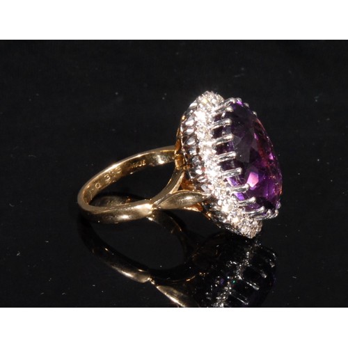 1396 - A large amethyst and diamond ring, central oval deep purple amethyst measuring approx 12.7mm x 17.8m... 