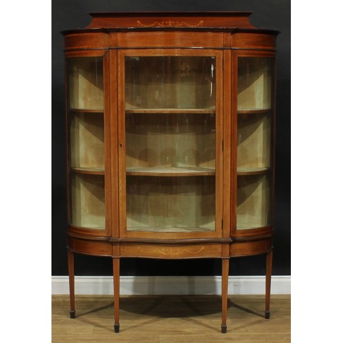 1887 - An Edwardian satinwood crossbanded mahogany and marquetry serpentine display cabinet, shaped pedimen... 