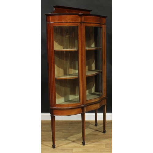 1887 - An Edwardian satinwood crossbanded mahogany and marquetry serpentine display cabinet, shaped pedimen... 