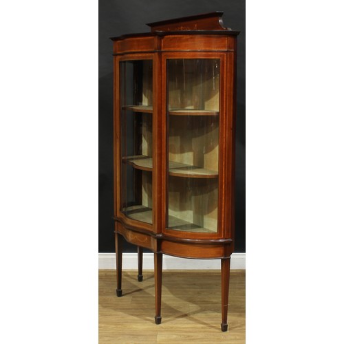 1887 - An Edwardian satinwood crossbanded mahogany and marquetry serpentine display cabinet, shaped pedimen... 