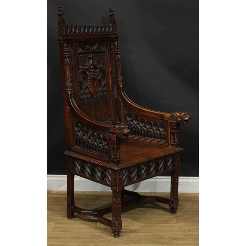 2058 - A late 19th century Gothic Revival throne-form chair, the back centred by a shield-shaped armorial, ... 