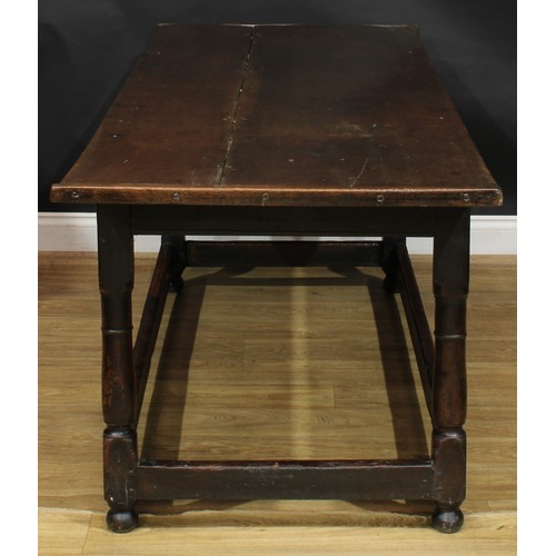 2005 - An 18th century oak refectory table, rectangular top, turned and blocked supports, rectangular stret... 