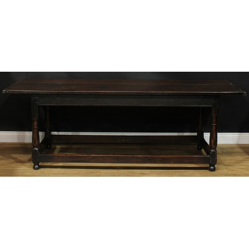 2005 - An 18th century oak refectory table, rectangular top, turned and blocked supports, rectangular stret... 