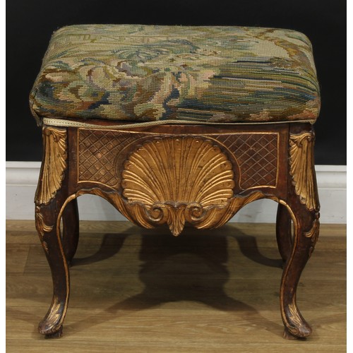 1971 - A pair of George II Revival parcel-gilt stools, stuffed-over upholstery, the frieze carved with a sh... 