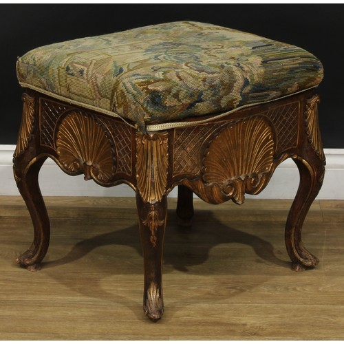 1971 - A pair of George II Revival parcel-gilt stools, stuffed-over upholstery, the frieze carved with a sh... 