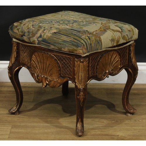 1971 - A pair of George II Revival parcel-gilt stools, stuffed-over upholstery, the frieze carved with a sh... 