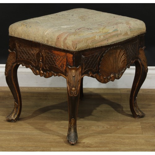 1971 - A pair of George II Revival parcel-gilt stools, stuffed-over upholstery, the frieze carved with a sh... 