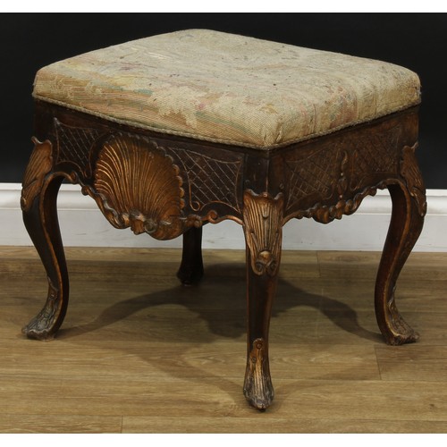 1971 - A pair of George II Revival parcel-gilt stools, stuffed-over upholstery, the frieze carved with a sh... 