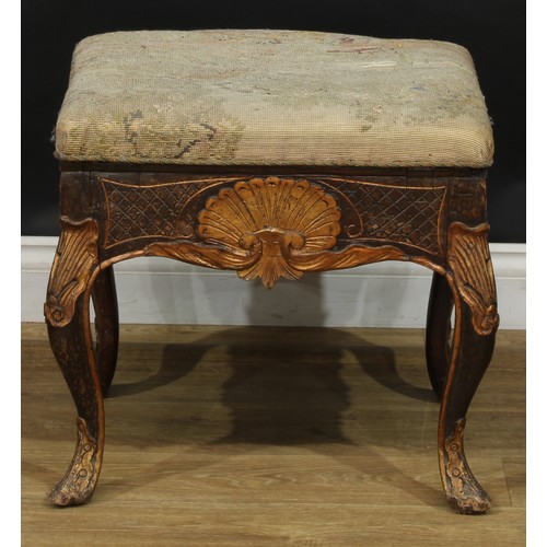 1971 - A pair of George II Revival parcel-gilt stools, stuffed-over upholstery, the frieze carved with a sh... 