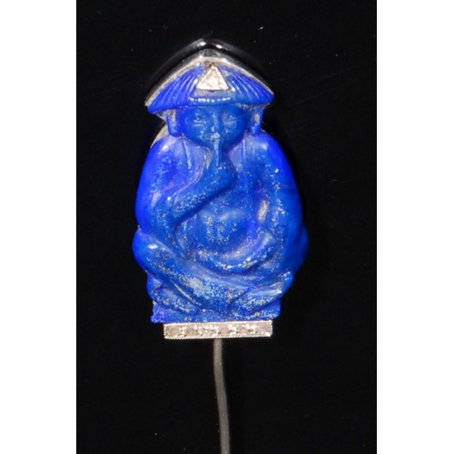 1386 - A French blue stone and diamond tie pin, the blue top section carved as a seated Chinese figure in c... 