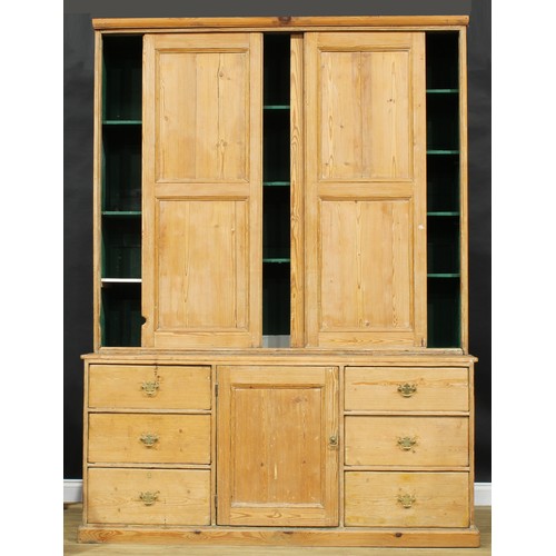 2226 - A substantial 19th century pine housekeeper’s cupboard, moulded cornice above three sliding panel do... 