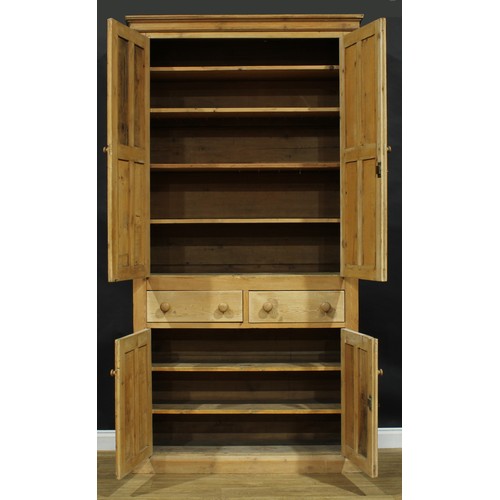 2227 - A substantial late 19th century pine housekeeper’s cupboard, moulded cornice above a pair of panel d... 