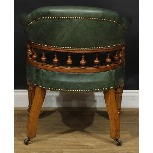 1956 - A late Victorian oak club or desk chair, stuffed-over green hide upholstery, studded borders, turned... 