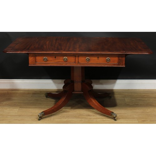 2231 - A Regency flame crossbanded mahogany sofa table, rounded rectangular top with fall leaves above a pa... 