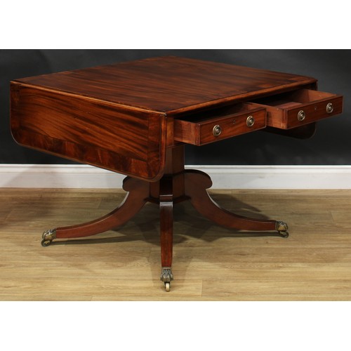 2231 - A Regency flame crossbanded mahogany sofa table, rounded rectangular top with fall leaves above a pa... 