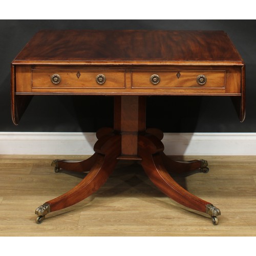 2231 - A Regency flame crossbanded mahogany sofa table, rounded rectangular top with fall leaves above a pa... 