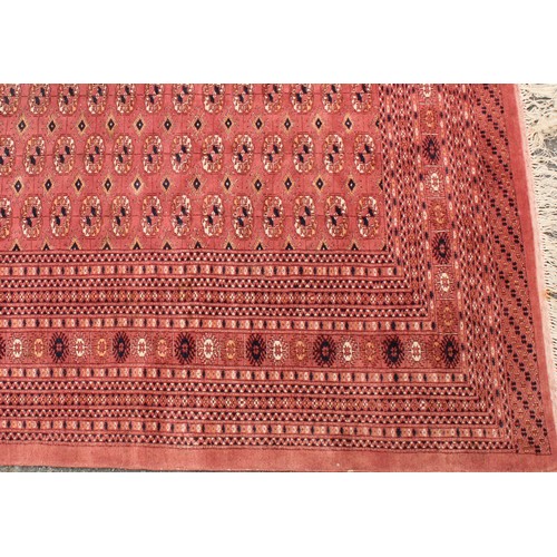 2574 - A Tekke Turkmen wool rug or carpet, worked in the traditional Bokhara design, 306cm x 220cm