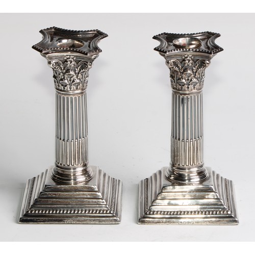 1035 - A pair of Victorian silver Corinthian column candlesticks, stepped square bases, 15.5cm high, London... 