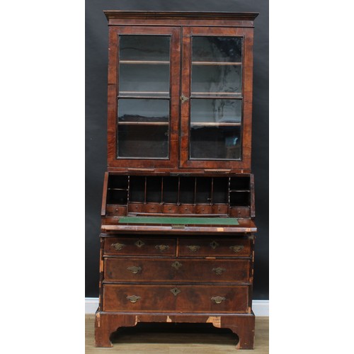 1728 - A George I/II walnut bureau bookcase, moulded cornice above a pair of glazed doors and candle slides... 