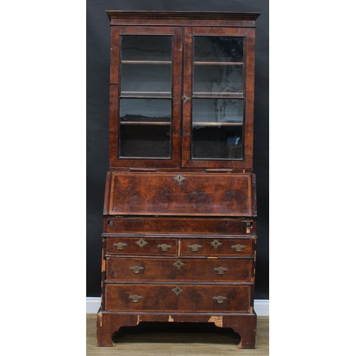 1728 - A George I/II walnut bureau bookcase, moulded cornice above a pair of glazed doors and candle slides... 