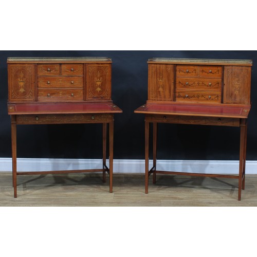 1980 - A pair of Sheraton Revival mahogany and marquetry bonheurs du jour, each with a shallow brass three-... 