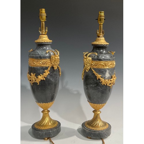 2023 - A pair of Louis XVI style gilt metal mounted marble table lamps, each applied with Bacchus masks and... 