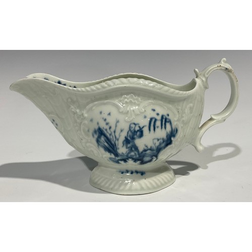 179 - A first period Worcester blue and white sauceboat, the whole press moulded and painted with Chinese ... 