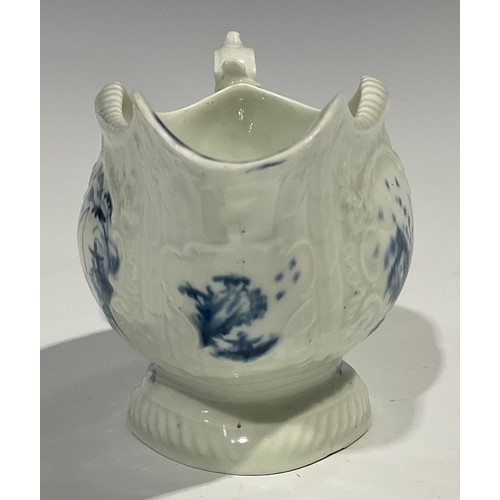 179 - A first period Worcester blue and white sauceboat, the whole press moulded and painted with Chinese ... 