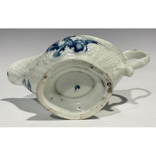 179 - A first period Worcester blue and white sauceboat, the whole press moulded and painted with Chinese ... 