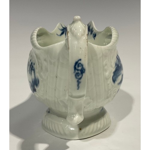 179 - A first period Worcester blue and white sauceboat, the whole press moulded and painted with Chinese ... 