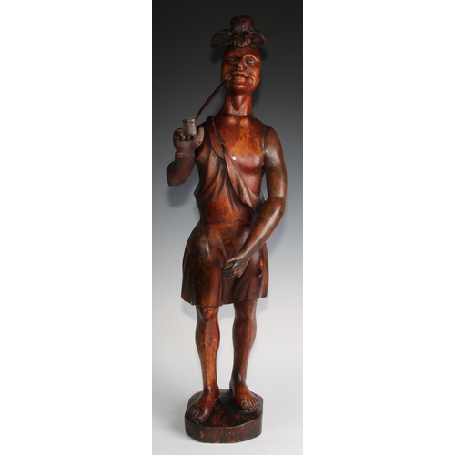 1557 - A 19th century carved tobacconists advertising figure as a native American, standing wearing feather... 