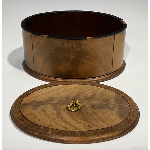 1805 - A late 19th century oval mahogany box and cover, crossbanded and outlined with ebony stringing, moul... 