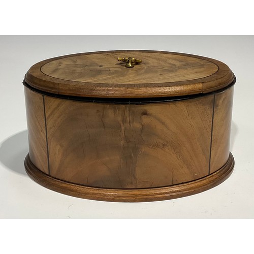 1805 - A late 19th century oval mahogany box and cover, crossbanded and outlined with ebony stringing, moul... 