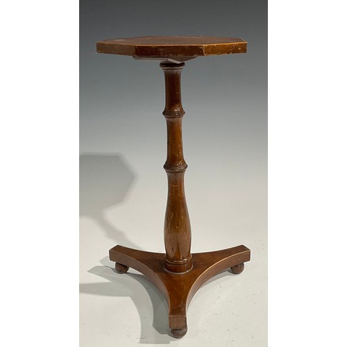 1696 - A 19th century mahogany octagonal candle stand, the cross banded top outlined with boxwood stringing... 